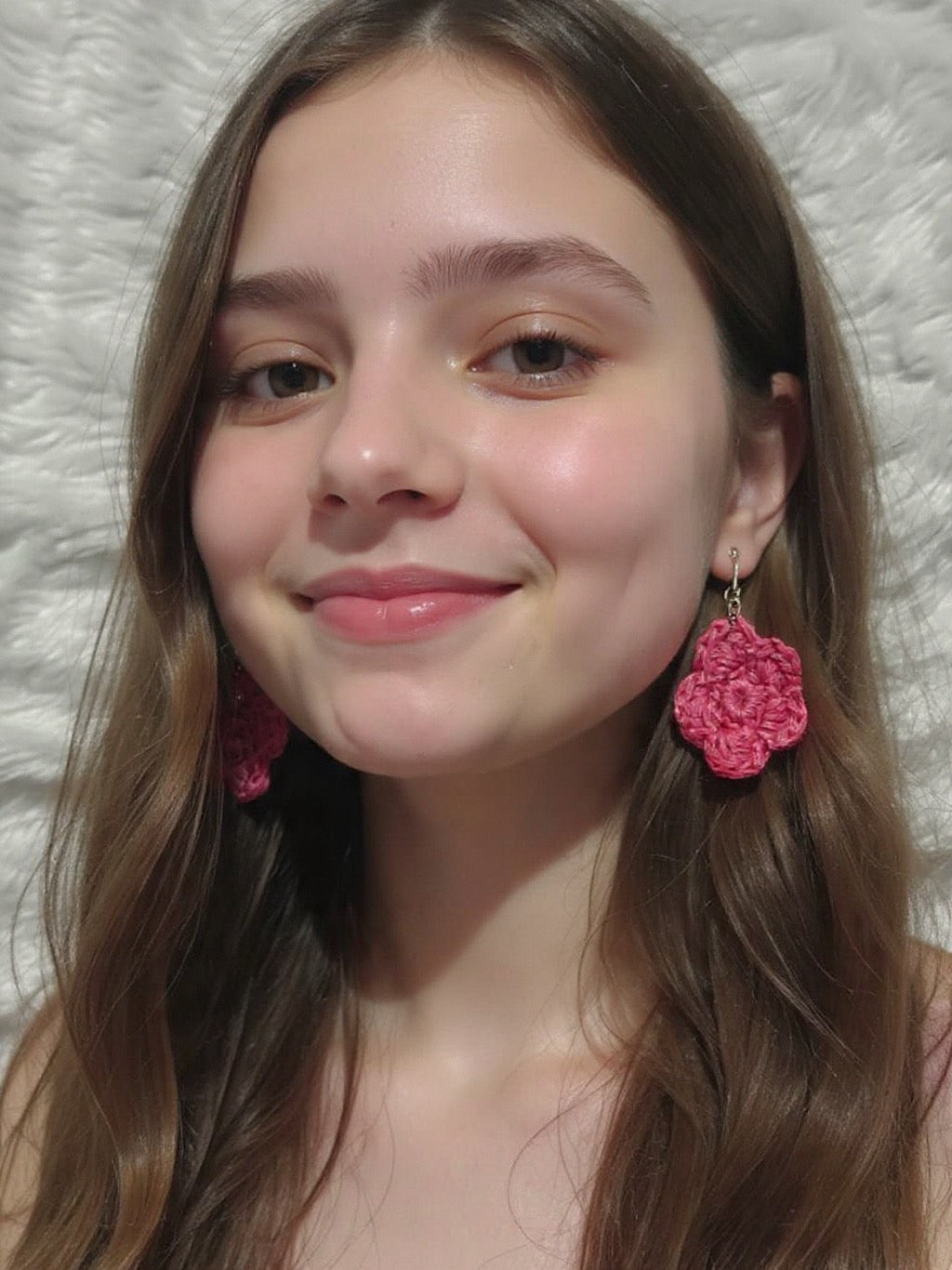 Woman wearing pink floral earrings 

